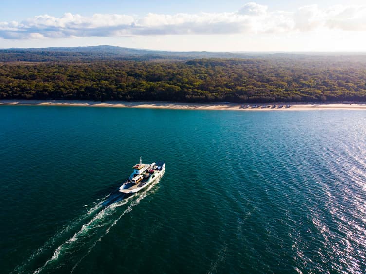 A boat on the ocean near a beach