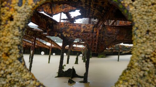 Shot taken through a porthole of a shipwreck on a beach