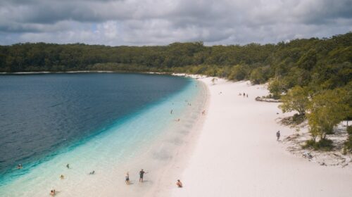 Aerial photo of swimmers at Lake McKenzie's shore