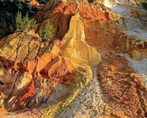 A rocky cliffside with colourful rocks