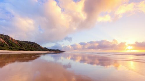 A flat beach at sunset