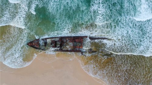 An aerial shot of a shipwreck on a beach